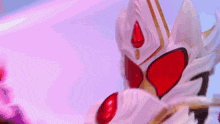 a close up of a robot with red eyes and a crown