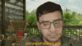 a man wearing glasses says peruquete ama vcs in a blurry picture
