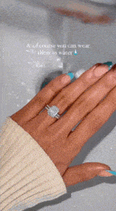 a close up of a woman 's hand with a diamond ring