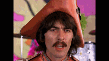a man with a mustache wearing an orange hat