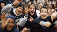 a group of young people are laughing and giving a thumbs up sign