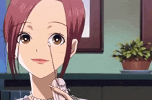 a girl with red hair is talking on a telephone with the letter b on it