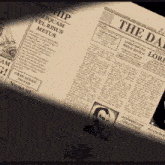 a close up of a newspaper that says the day