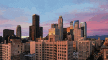 an aerial view of a city skyline with a pink sky