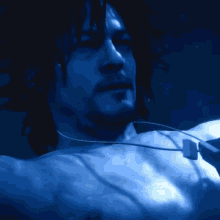 a close up of a man 's face in a blue light