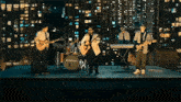 a band playing instruments on a stage with a drum set that says edgenote