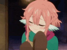 a girl with pink hair and ears is kneeling down with her eyes closed and smiling .