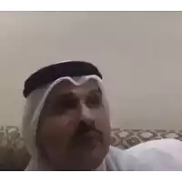 a man with a mustache and a turban is sitting on a couch and making a funny face .