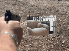 a person is pointing a gun at a picture of a chair with the words the downpour above it