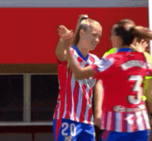 a woman in a red and white striped shirt with the number 20 on the back
