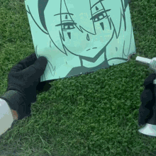 a person is holding a piece of paper with a drawing of a girl