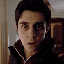 a close up of a person 's face with a surprised look on his face
