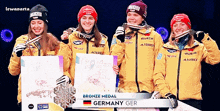 four female athletes from germany are holding a bronze medal