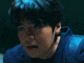 a close up of a man 's face with a backpack behind him