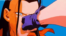 a close up of a cartoon character 's face with a purple object in his mouth .