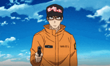 a man in a tokyo ffs jacket holds a gun in front of a blue sky