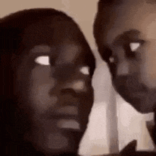 a man and a woman are looking at each other in a close up of their faces .