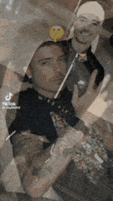 a man with a tattoo on his arm is wearing a nike air sweatshirt