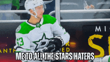 a hockey player in a green and white jersey with the number 43 on it