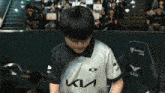 a person wearing a black and white shirt with the letter k on it
