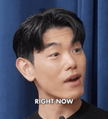a close up of a man 's face with the words `` right now '' written on the bottom .