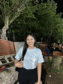 a woman wearing a t-shirt that says ' jesus ' on it smiles for the camera