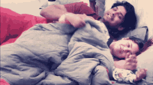 a man and a woman are wrapped in a blanket