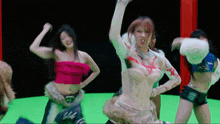 a group of women are dancing together on a green screen