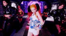 a group of women are dancing in a room in a video .