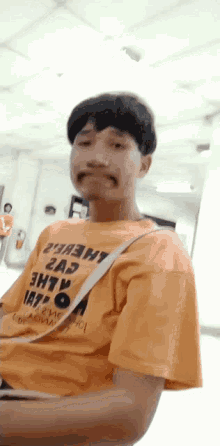 a man wearing a yellow shirt that says " 2a3 "