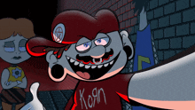 a cartoon character wearing a red shirt that says korn on it
