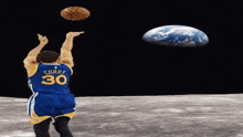 a man in a curry 30 jersey throws a basketball at the earth