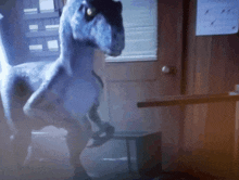 a dinosaur is standing in a room with a calendar on the wall