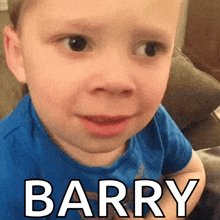 a young boy in a blue shirt is making a funny face and the word barry is on the bottom of his face .