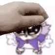 a hand is petting a cat with a purple bow tie .