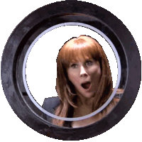 a woman with a surprised look on her face is behind a round window