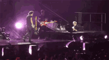 a blurry photo of a man playing a guitar on stage