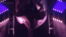a woman in a hawaiian shirt walks through a tunnel of lights