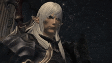 a man with long white hair and ears is standing in the dark
