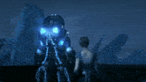 a woman in a blue dress stands next to a man in a futuristic suit