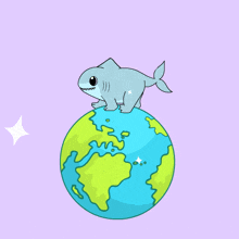 a shark is sitting on top of a globe