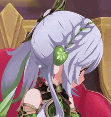 a girl with white hair and green leaves in her hair is sitting on a couch .