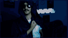 a man wearing sunglasses and a hooded jacket is standing in a dark room with a clock in the background