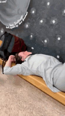 a person laying on a wooden bench with a chalkboard behind them that says ' i love you ' on it