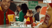 alvin the chipmunk says call me while sitting at a table with a group of people