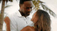 a man and a woman are looking at each other