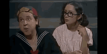 a man and a woman are sitting next to each other .