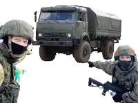 two soldiers standing in front of a truck that says kamaz on it