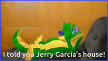 a cartoon of a lizard laying on a couch with the words i told you jerry garcia 's house below it