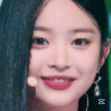 a close up of a woman 's face with a microphone behind her .